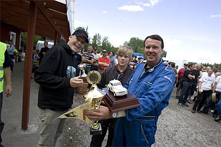 Vinnarteamet Torsten Andersson och hans son Fredrik Farsfalk tar emot prisbucklan av Klassikers chefredaktör Carl Legelius.