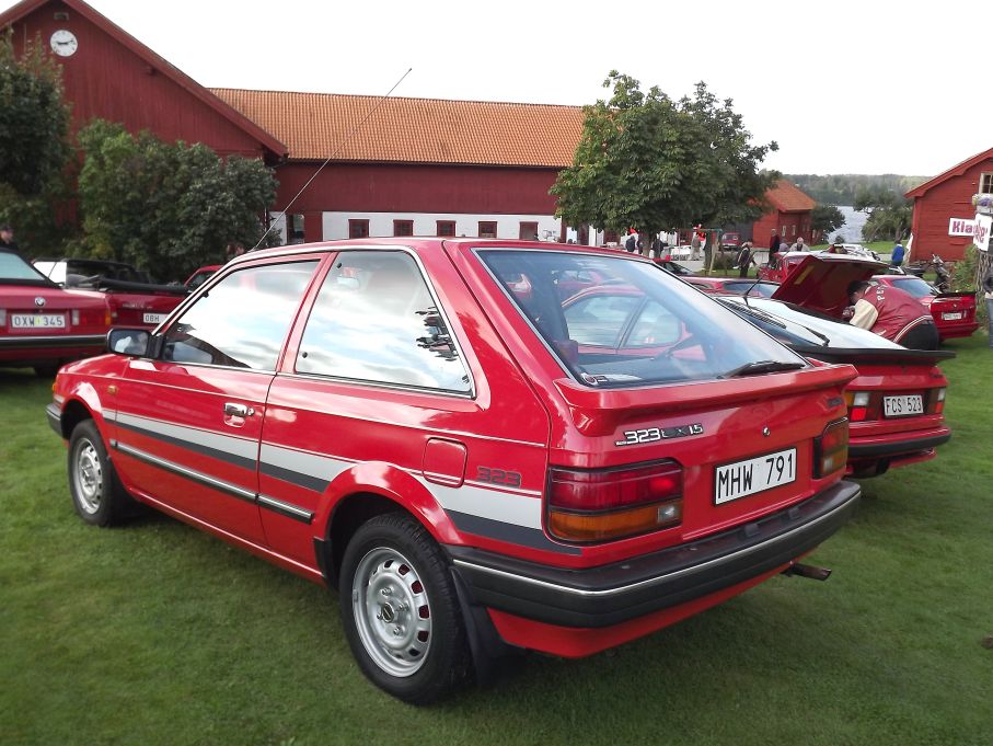 Mazda 323LX från 1987, utan snurrande motor men med tuffa stripes.